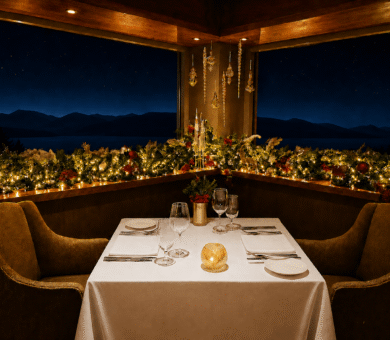 Elegant dining with romantic candlelight, mountain view, and festive decor at luxury hotel restaurant at night.