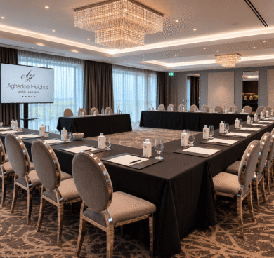 Elegant conference room with chandelier lighting, U-shaped table setup, and AV equipment at Aghadoe Heights Hotel.