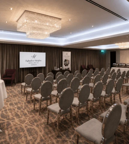 Elegant hotel conference room with plush chairs, modern chandeliers, and a welcoming atmosphere for events.