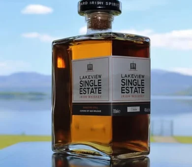 Lakeview Single Estate Irish Whiskey bottle with mountain lake view in background